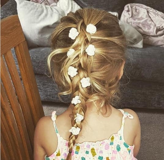 Combed Back Hairstyle With Braided Ponytail And Flowers