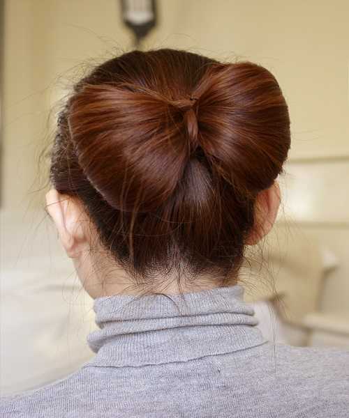 Tight Combed Back Hairstyle With Big Bow