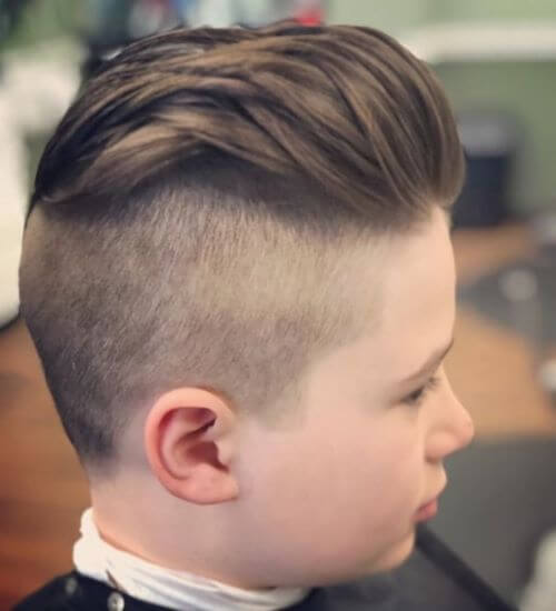 Slicked Back Hairstyle With A Mid Fade