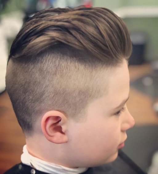 Slicked Back Hairstyle With A Mid Fade