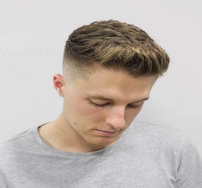   Brushed Up Hairstyle With Texture And High Fade