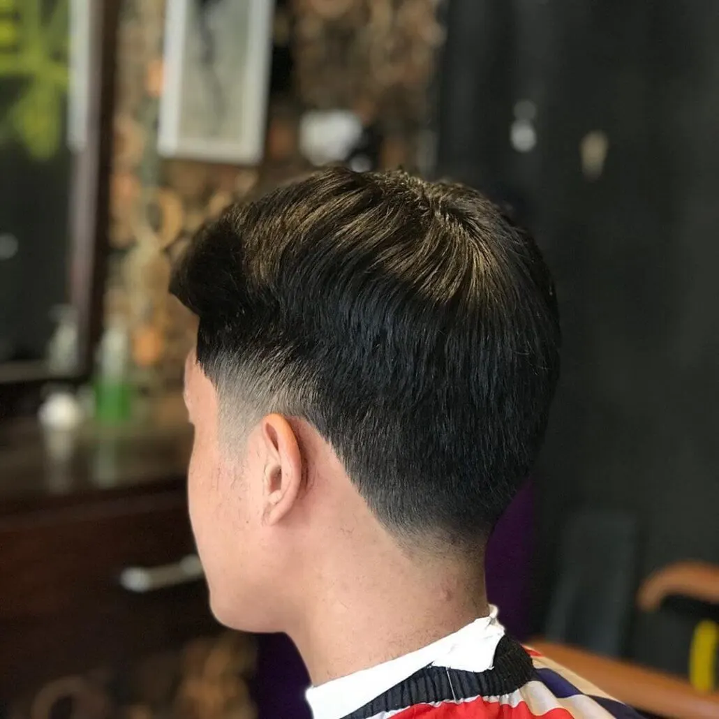 Center-Parted Hairstyle With Mid Fade