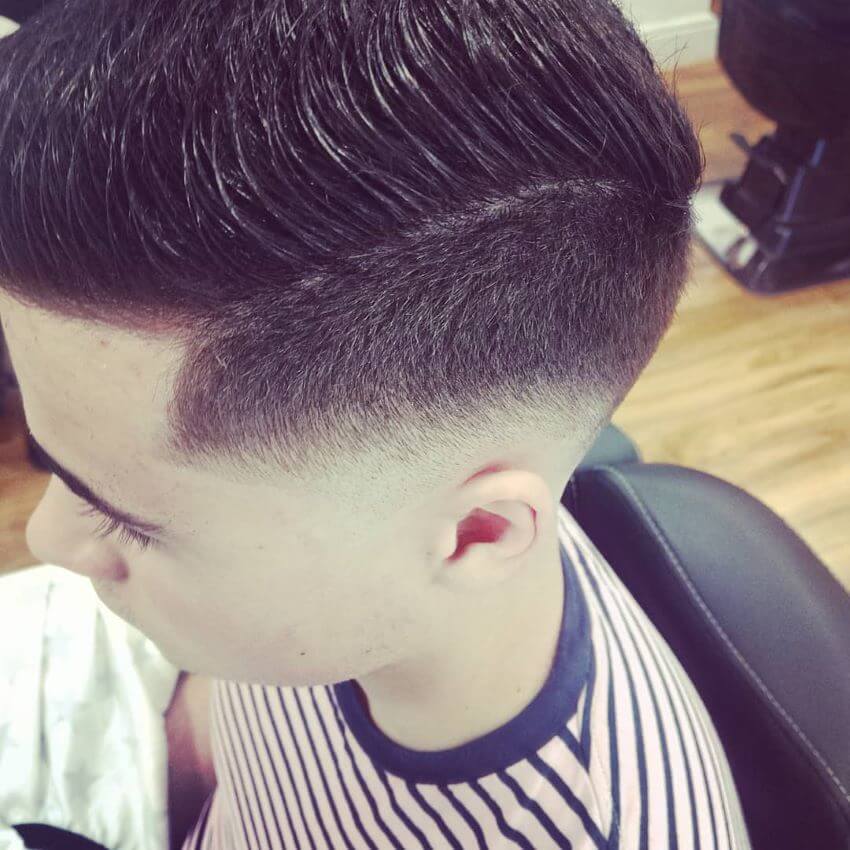 Textured Combed Back Hairstyle With Low Fade