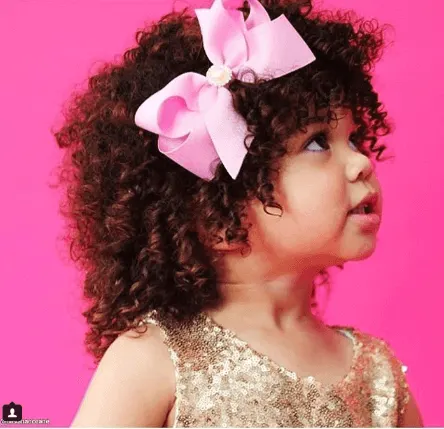 Curly Top Styled With A Ribbon Bow